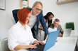 © Tandem - Business team of men and women in an office