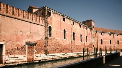 Sticker - Exterior view of an old building along a canal in Venice, Italy, in the summertime