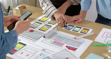 Creative web site developers create interface design from sketches. Engineers are working on an application for smartphones. User experience.
