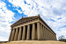 Low Angle Shot Of The Parthenon In Nashville, Tennesee Under A Bright Cloudy Sky On A Sunny Day