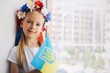 portrait of a little Ukrainian girl.
Flag of Ukraine in the child's arms. War. Pray for Ukraine.