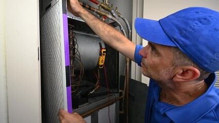 Wall Mural - HVAC Technician Installing a Furnace Filter