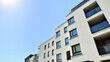 © Grand Warszawski - Exterior of new apartment buildings on a blue cloudy sky background. No people. Real estate business concept.