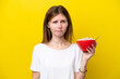 © luismolinero - Young English woman holding cup of coffee isolated on yellow background with sad expression
