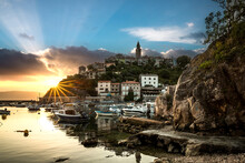 Skyline Of The Town Of Vrbnik On The Island Of Krk, Croatia. Harbor And Mountain Village At Sunrise, City Panorama