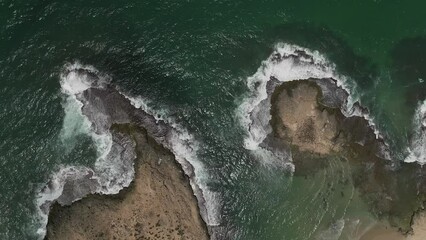 Wall Mural - Ocean Waves breaking on a coral reef rocks, Aerial footage.