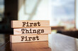Wooden blocks with words 'First Things First'.