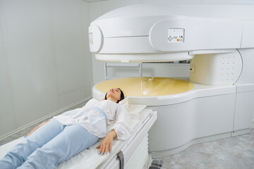 Wall Mural - Woman patient is ready to do magnetic resonance imaging MRI or CT scan in clinic
