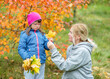 © Ermolaev Alexandr - Mother and little girl with Downs syndrom have a fun in autumn park