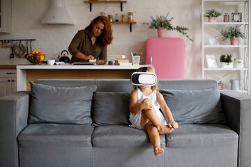 little girl with virtual reality glasses at home