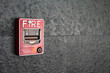 © Nattawit - A fire alarm trigger box which is installed on building wall. Emergency and safety equipment object photo. Selective focus.