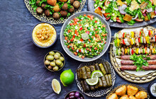 Arabic Cuisine;Assorted Of Middle Eastern Traditional Dishes. Stuffed Vine Leaves,olives, Kibbeh, Shish Tawook, Flafel, Sambusak, Tabbouleh And Fattoush Salad. Halal Food. Top View With Copy Space.