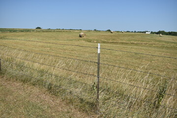 Poster - Barbed Wire Fence and Hay Bales in a Farm Field