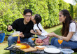 © atitaph - Asian family happy bright cute daughter Barbecuing in the courtyard