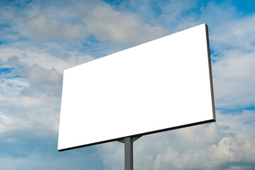 Mock up - blank white billboard or large advertising display against blue sky with white clouds. Consumerism, white screen, template, mock up and copy space concept