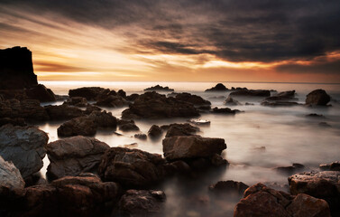 Wall Mural - O'Sullivans Beach shoreline with clouds over sea at sunset.