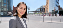 Young Confident Successful Smiling Asian Business Woman Entrepreneur Wearing Suit Standing On City Street Advertising Business Trainings, Corporate Services, Workshop, Portrait. Banner With Free Space