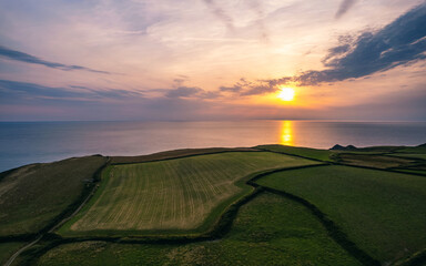 Wall Mural - Sunset over Fields and Farms of Caunter Beach and Cliffs, Hartland Cornwall Heritage Coast, South West Coast Path, Bude, North Cornwall, England