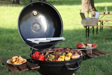 Tasty meat and vegetables on barbecue grill outdoors