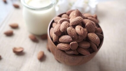 Wall Mural -  almond nut and milk on table 