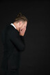 © Arunporn - Portrait of handsome businessman in black suit feel stressed and disappointed emotion isolated on black background