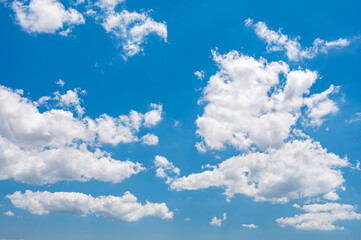Wall Mural - deep blue skies with white clouds background with space for text, blue cloudy skies texture