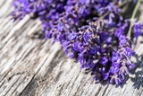 Fototapeta Lawenda - close up of bunch of lavenders on wooden table