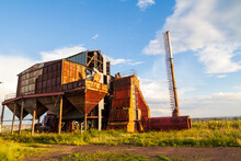 Old Abandoned Agricultural Building With Rusty Iron Walls. Soviet And Russian Rural