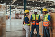 © sarayutsridee - Warehouse Workers Checking Stock with digital Tablet in Logistic center. Asian Worker Team wearing hard hat and safety vests to talking about shipment in storehouse, Working in Distribution Center.