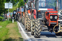 Column Of Tractors At Protests. Farmers At Demonstrations. Blocking The Road With Tractors.
