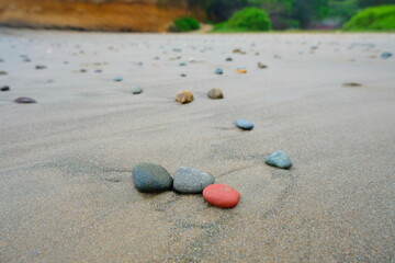 Close up of stone in the beach sand background with white stone. Sandy beach texture