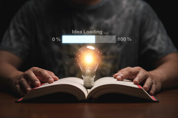 Wall Mural - Glowing lightbulb on open book with virtual loading idea bar for creative thinking of problem solving and education knowledge concept.