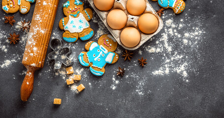 Poster - Christmas gingerbread on dark background top view. Xmas holiday celebration and cooking concept