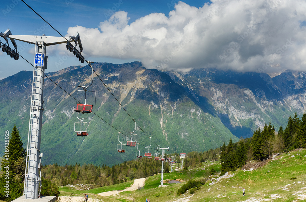 Velika Planina or Big Pasture Plateau in the Kamnik Alps, Slovenia. Mountain cottage hut or house on green hill. Alpine meadow landscape. Cable car