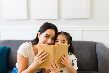 Happy family reading together a beautiful children's book