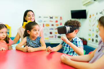 Wall Mural - Happy kids using virtual reality technology in preschool