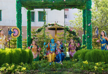 Colorful life size idols of Krishna, Radha sitting and swing at Prem Mandir temple. Happy Krishna Janmashtami.  selective focus on subject.