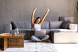 © F8  \ Suport Ukraine - Pretty woman celebrating something while working with laptop sitting on a couch at home.