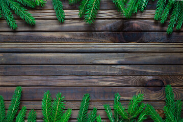 Wall Mural - Christmas background with fir tree  on dark wooden board	