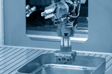 Wall Mural - The automatic  robotic arm gripping the metal parts from CNC lathe machine.