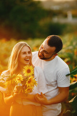 Wall Mural - People spend time in a sunflowers field