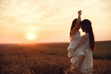 Mother with daughter playing in a summer field