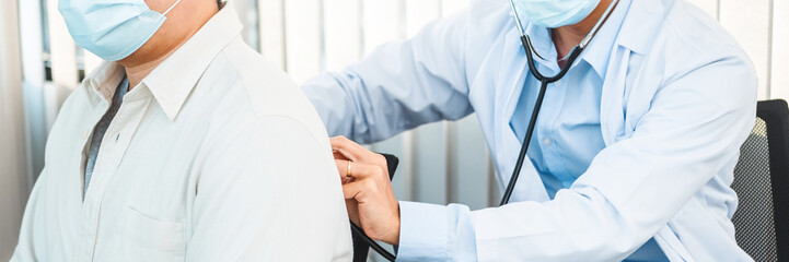 Wall Mural - Doctor listening to patients breathing sound with Stethoscope