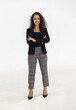 © Danai - Portrait of smart caucasian businesswoman with curly hair in black jacket suite with trousers smiling arm crossed isolate on white background, vertical full body studio shot