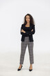 © Danai - Portrait of smart caucasian businesswoman with curly hair in black jacket suite with trousers smiling arm crossed isolate on white background, vertical full body studio shot