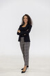 © Danai - Portrait of smart caucasian businesswoman with curly hair in black jacket suite with trousers smiling arm crossed isolate on white background, vertical full body studio shot
