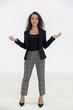 © Danai - Portrait of smart caucasian businesswoman with curly hair in black jacket suite with trousers smiling hand spread isolate on white background, vertical full body studio shot