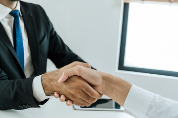 Wall Mural - Welcome. business people shaking hands after business signing contract in meeting room at company office, partner, job interview, investor, negotiation, partnership, teamwork, financial concept
