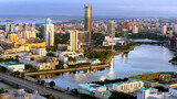 Fototapeta Miasto - Yekaterinburg, Russia, aerial view of the city with the Iset tower and the river with embankment. Stock footage. Drone view of the city center with wide road and many houses.