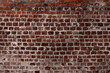 Dark red and brown brick wall textured background.